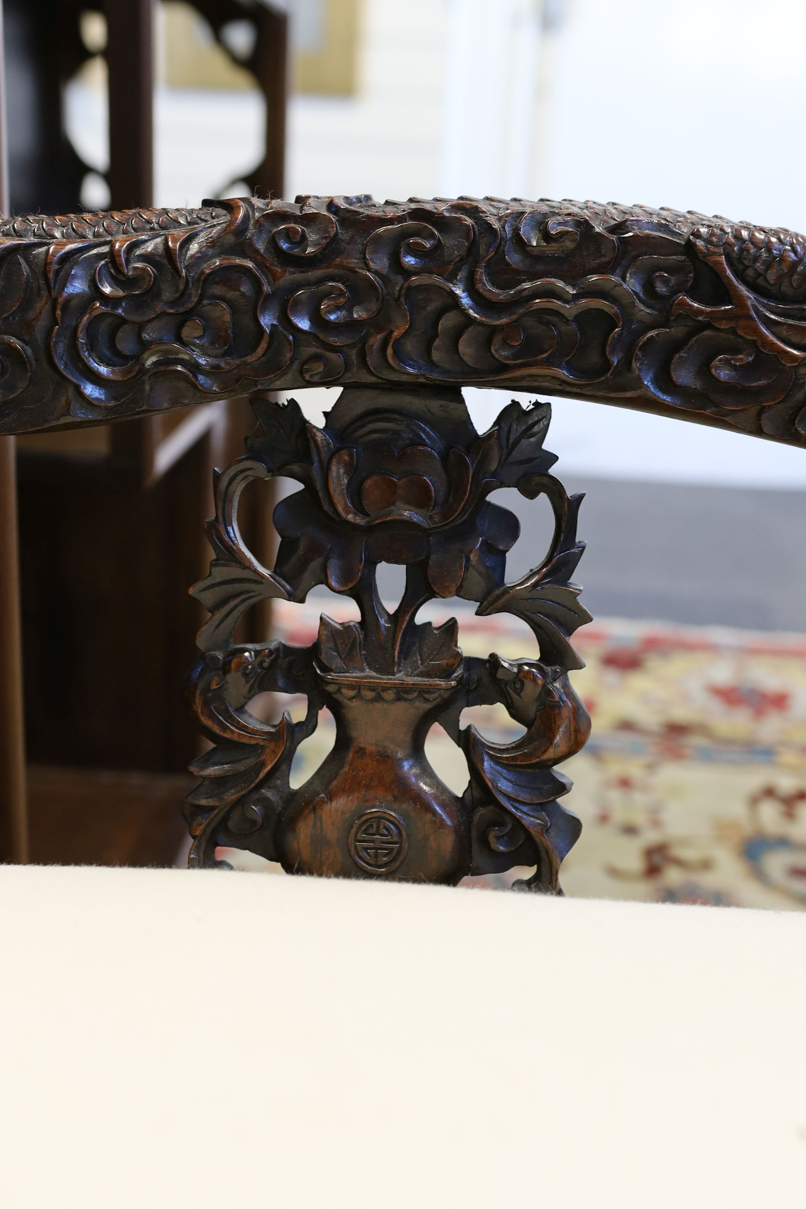 A good Chinese hardwood ‘dragon’ throne armchair, c.1900, 114.5cm high, 68cm wide at the arms